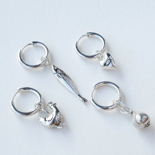 Sterling silver mono earrings on ear - all four designs